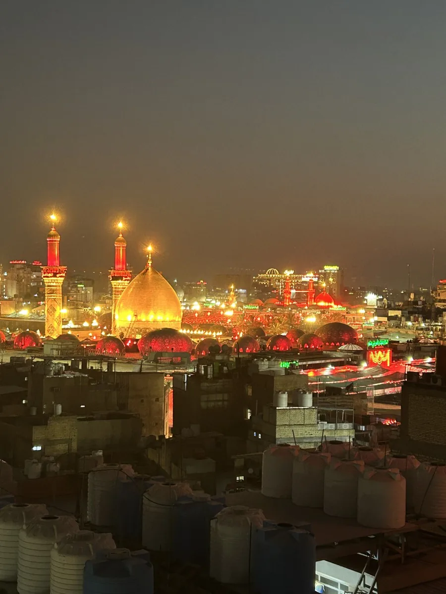 Illuminated shrine domes and minarets at night, photographed in the client’s pilgrimage archive
